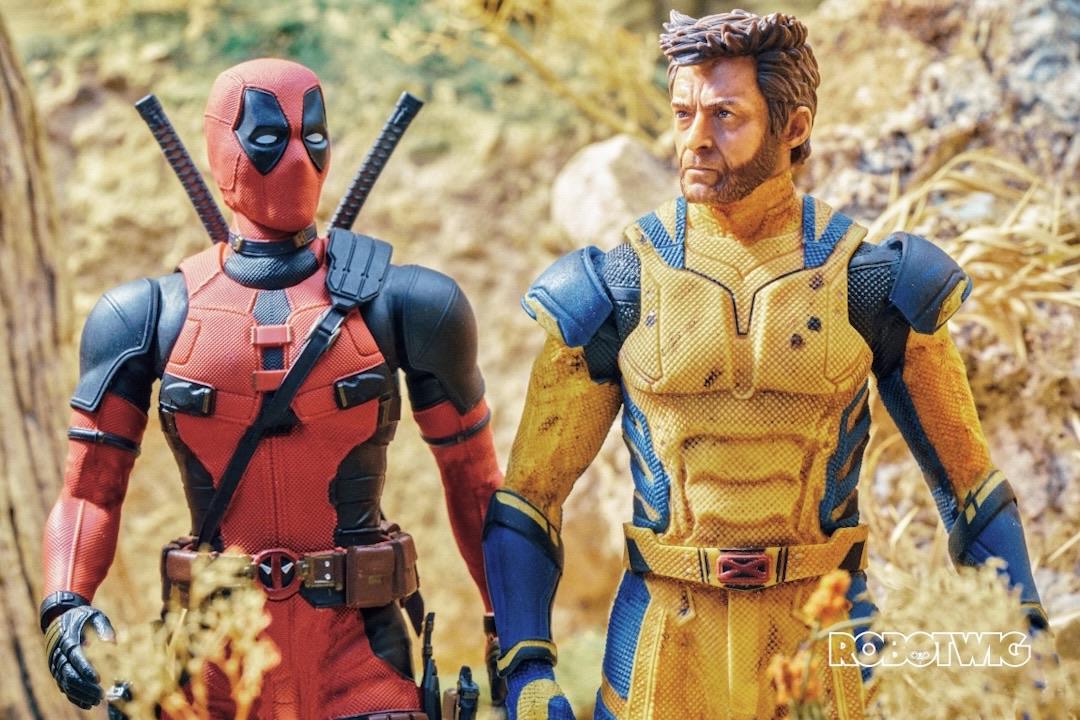 Deadpool and Wolverine walk through dry land on a hot sunny day looking to be having a heated conversation