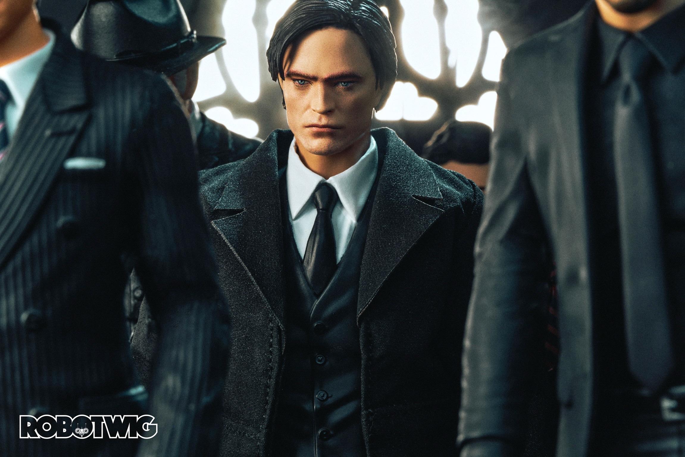 Bruce Wayne attends a funeral walking amongst many other people
