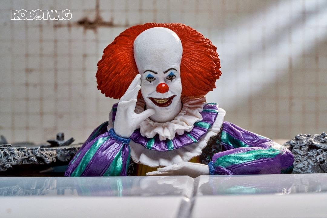 Pennywise comes out of the ground in the shower room to torment Eddie