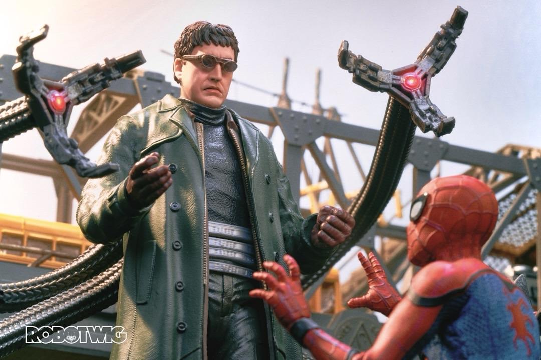 Doc Ock rises above Spiderman with his tentacles  under a busy freeway