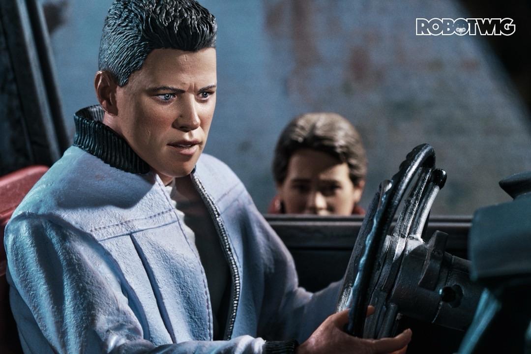 Biff listens to a baseball game on his car radio whilst driving through a tunnel. Marty can be seen sneaking around the car door on his hoverboard trying to get the Almanac back