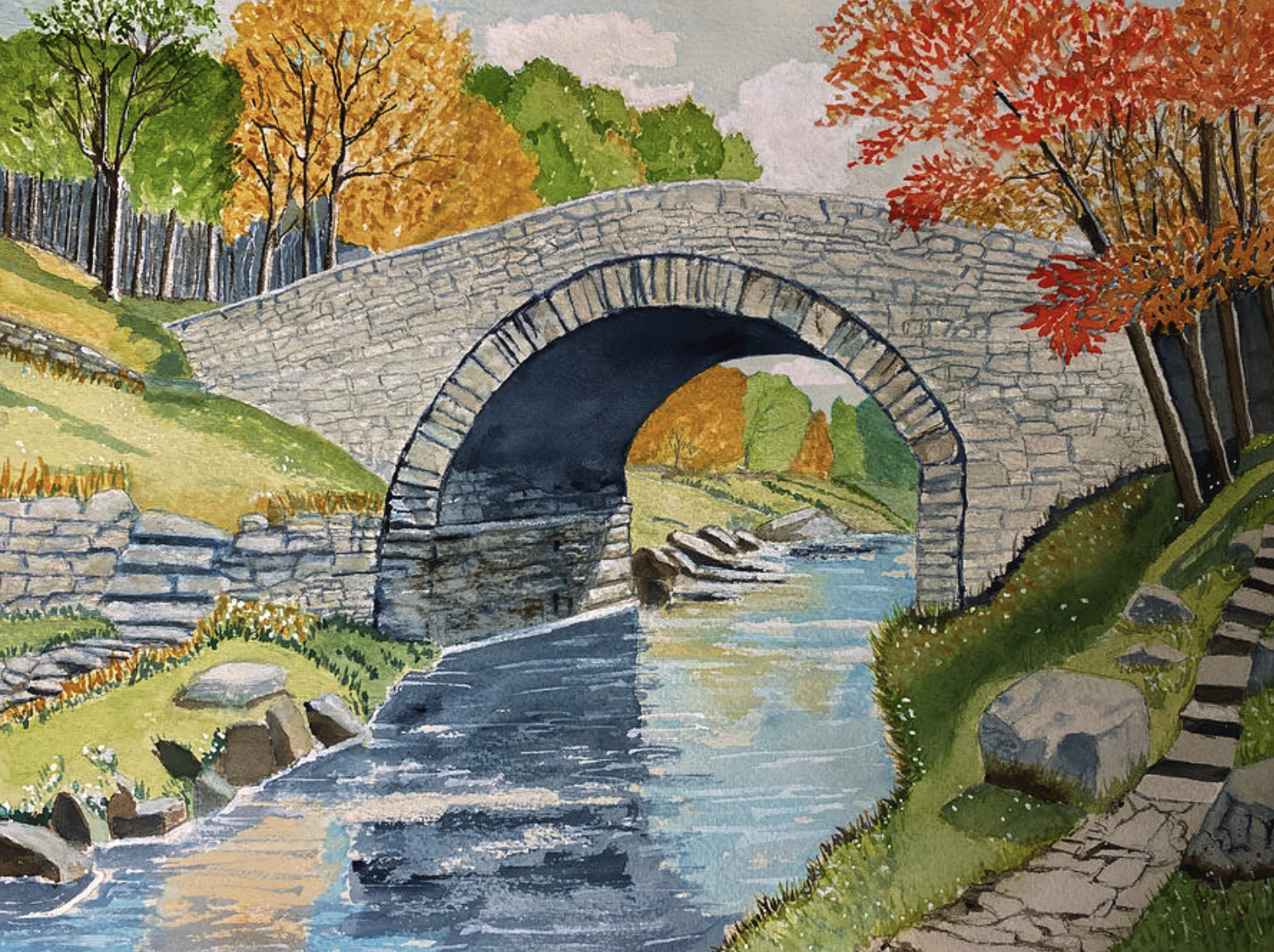 Deborah League’s watercolor of an old stone bridge over a stream, surrounded by autumn foliage.