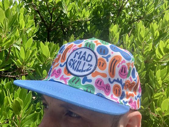A colorful hat that says “mad skillz”.