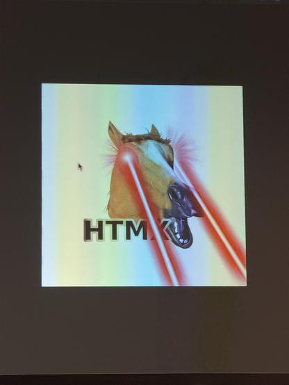 A horse with laser beams shooting out of its eyes over the letters “HTMX”