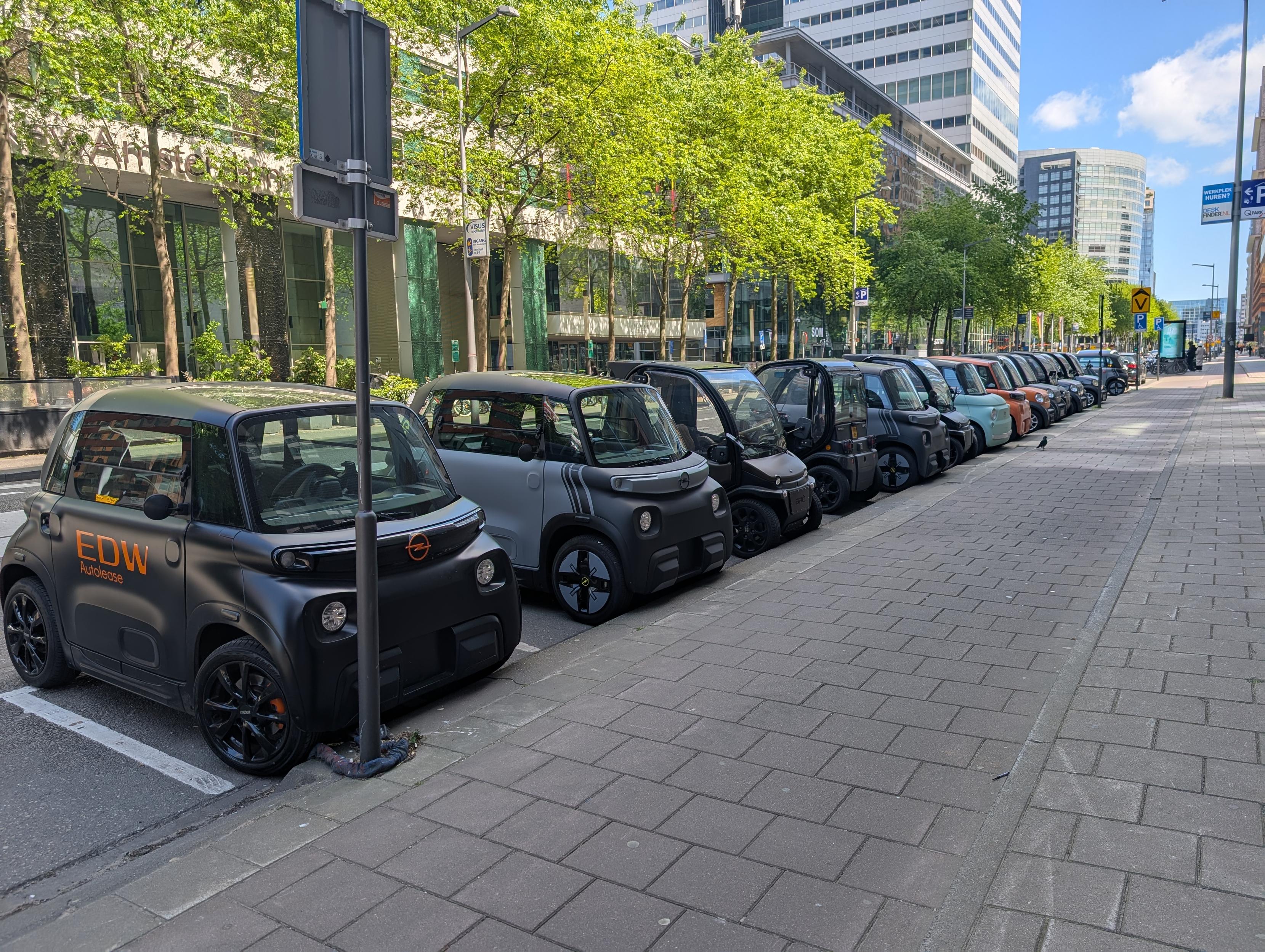 A line of microcars parked at Zuidas in Amsterdam A line of microcars parked at Zuidas in Amsterdam