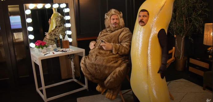 Jimmy Kimmel and Guillermo, watching the news, dressed as a furry and a bannana.
