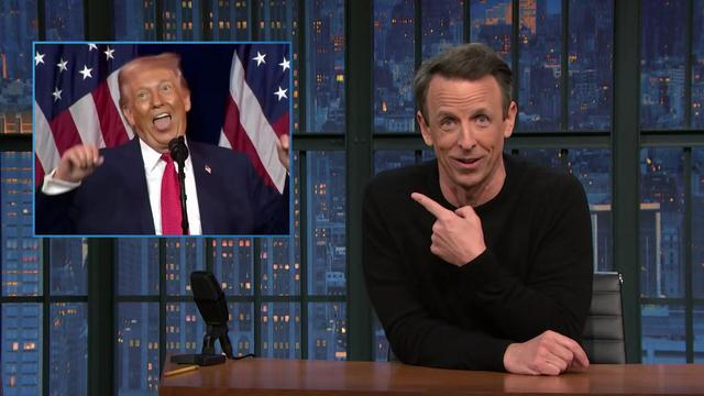Seth Meyers pointing at the photo of a slobbering Donald Trump during A Closer Look