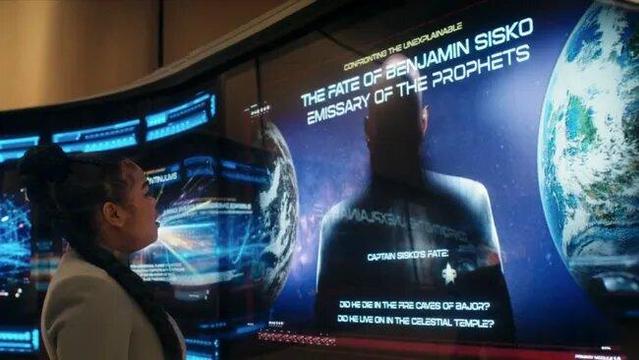 Series Acclimation Mil looking at a screen where it says: "The Fate of Benjamin Sisko, Emissary of the Prophets"