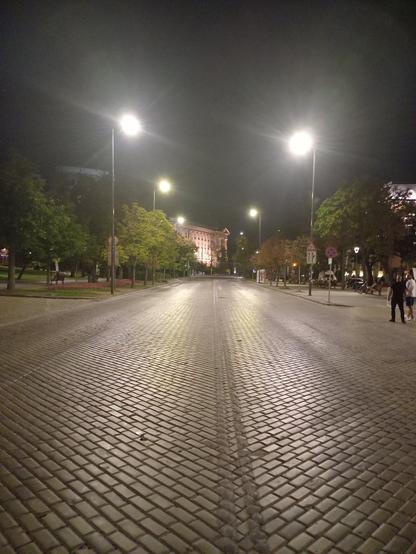 The yellow bricks road in the city centre of Sofia, Bulgaria, at midnight during a no-cars weekend. Part of Sofia University is visible in the distance.