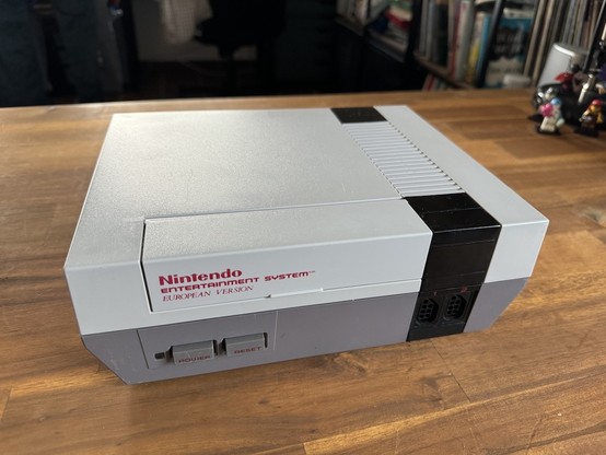 The same NES as in the first picture, but clean and restored to its original grey color.