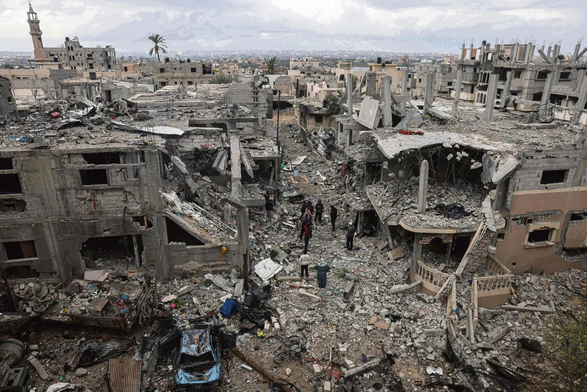 Couple of people walking through massive rubble in Gaza. Pic taken from L'humanité