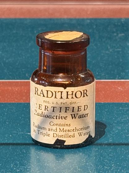 A bottle of Radithor water. The label states that it contains certified radioactive water both radium and mesothorium in triple distilled water. As seen in the collection at Science Museum of Minnesota’s Quackery Museum exhibit