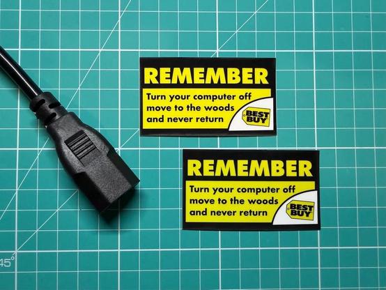 Two stickers that say remember to turn off your computer, move to the woods, and never return
