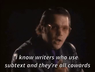 Garth Marenghi (a white man with slicked-back hair, wearing lightly-tinted sunglasses) saying emphatically, "I know writers who use subtext and they're all cowards."