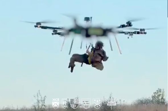 a man suspended in the air by a massive drone