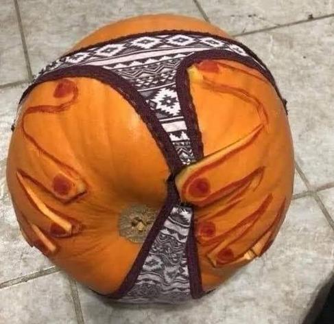 🎶thong thong thong thonnnng🎶
a pumpking wearing thong underwear with hands carved on either side.  The forefinger of one hand is pulling the thong to the side and exposing the bottom part of the pumpkin.
