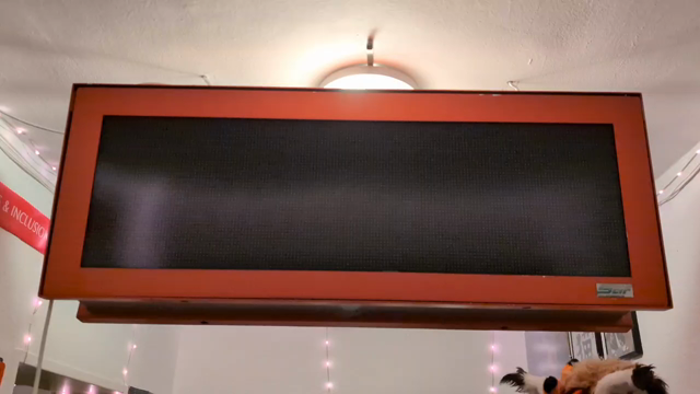 the display slowly building up an image consisting of clouds at the top and a road at the bottom, then a train, some buses and a tram scroll through while a plane flies through the air a bit slower
