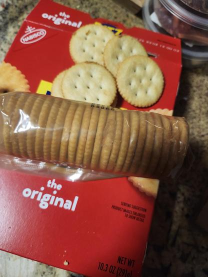 A picture of a sleeve of Ritz crackers with peanut butter visible through the sleeve.
