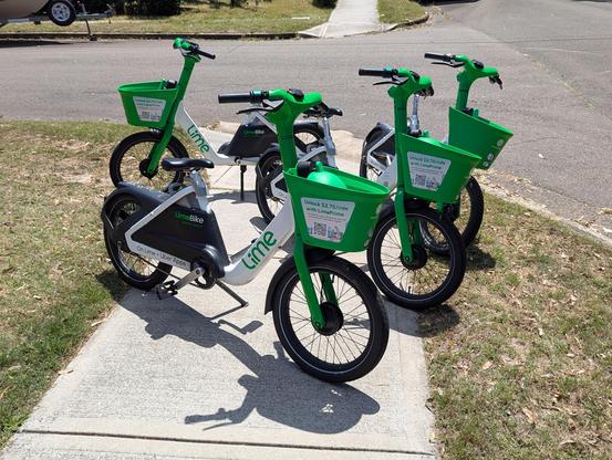 Pile of lime bikes arranged in such a way that they block the entire access to the footpath