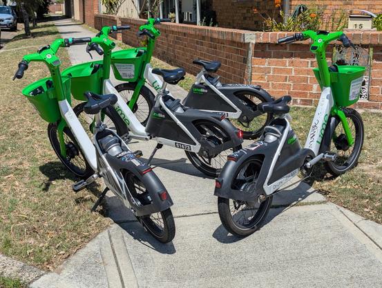 Pile of lime bikes arranged in such a way that they block the entire access to the footpath