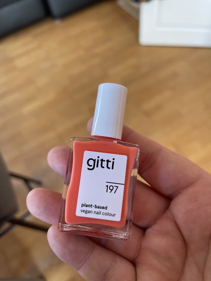 A bottle of gitti nail polish #197 in bright orange 