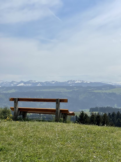 A bench in front of the alps 