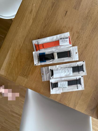 A bunch of different watch bands on a table 