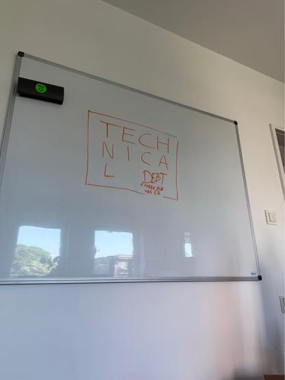 A whiteboard on which I scribbled „Technical Debt“ in a way that seems to follow a pattern at first and then loses it