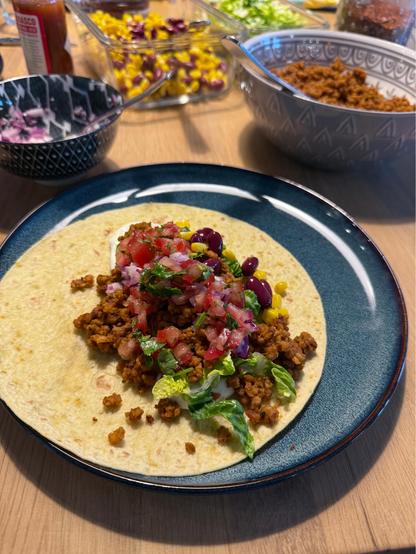 Taco with vegetarian meat, pico de gallo, lettuce, and salsa 