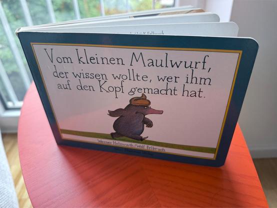 A kids book: „The Story of the Little Mole Who Went in Search of Whodunit“ or in German „Vom kleinen Maulwurf, der wissen wollte, wer ihm auf den Kopf gemacht hat“