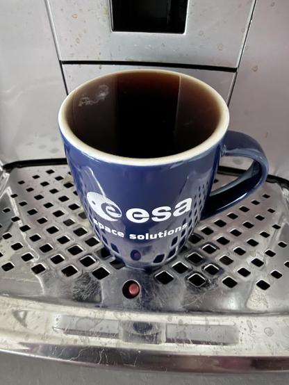 A cup of coffee from the European space agency filled to the very brim 