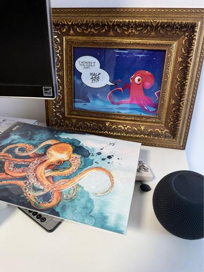 Photo of a printed framed comic of an octopus, saying „I wonder if you could just half-ass it“