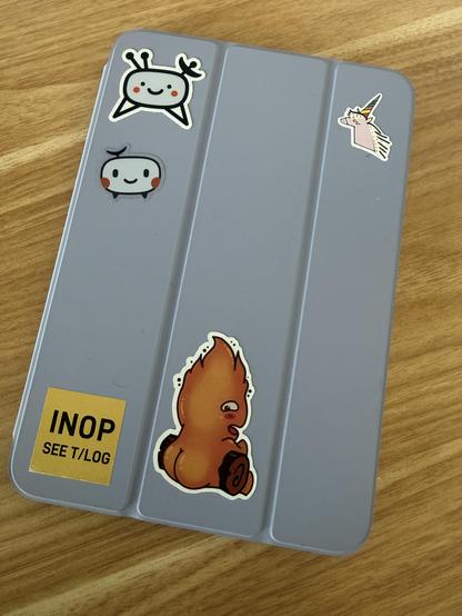 An iPad with these stickers:

- 2 TelemetryDeck Logos 
- a glitter unicorn 
- a sticker saying INOP (a pilot joke)
- and a flame spirit sitting on a log, but it’s from behind so you see its huge butt