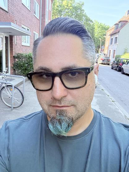 Selfie with a sidecut that is very short on the sides. Most of my hair is gray now 