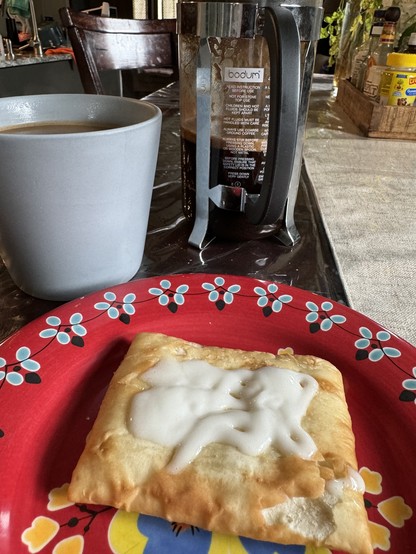 Coffee cup, French press, and a strudel 