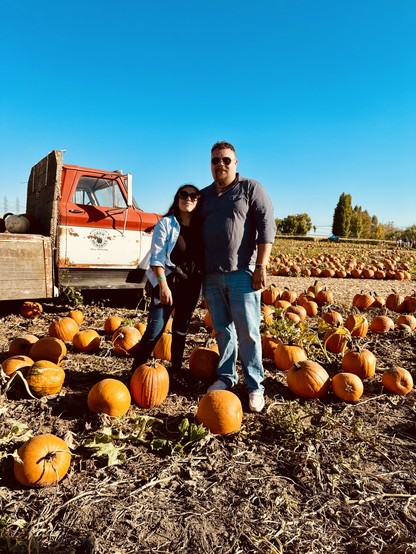 Photo of Jacob and wife Belinda in a pumpkin patch and truck behind us. 