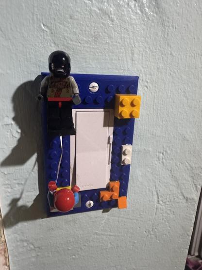 Photo of a Lego scene on a light switch. 