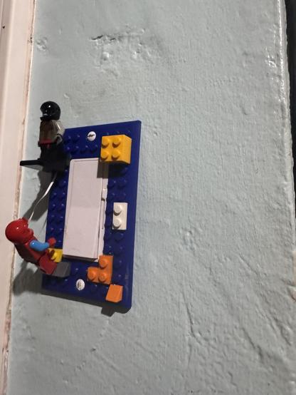 Photo of a Lego scene on a light switch. 