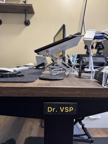 Desk with a name plate that says Dr VSP. 