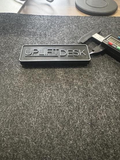 Name place that says UPLIFT DESK and a para of calipers. 