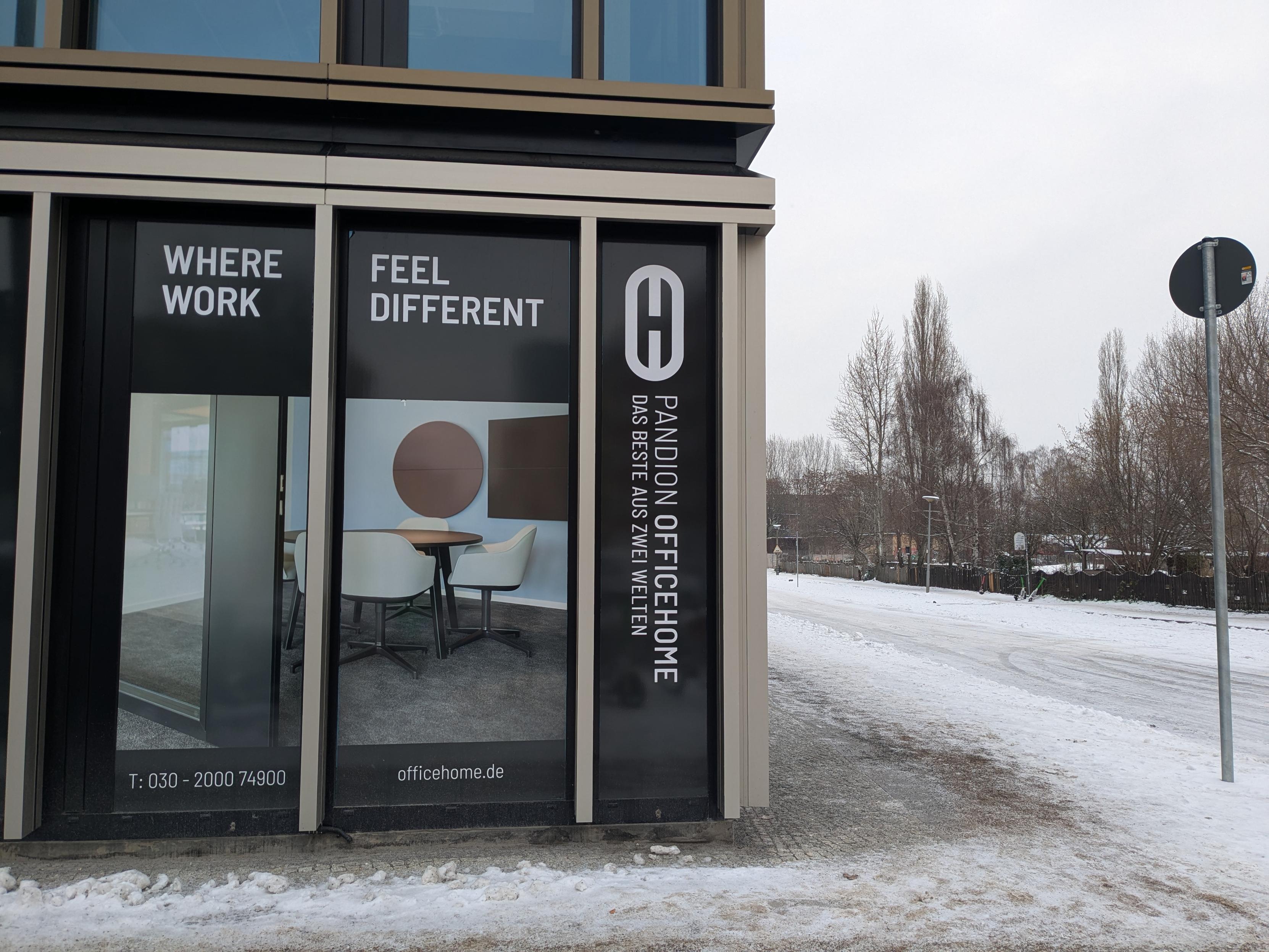 A photo of a corporate work hell building with a dumb sign