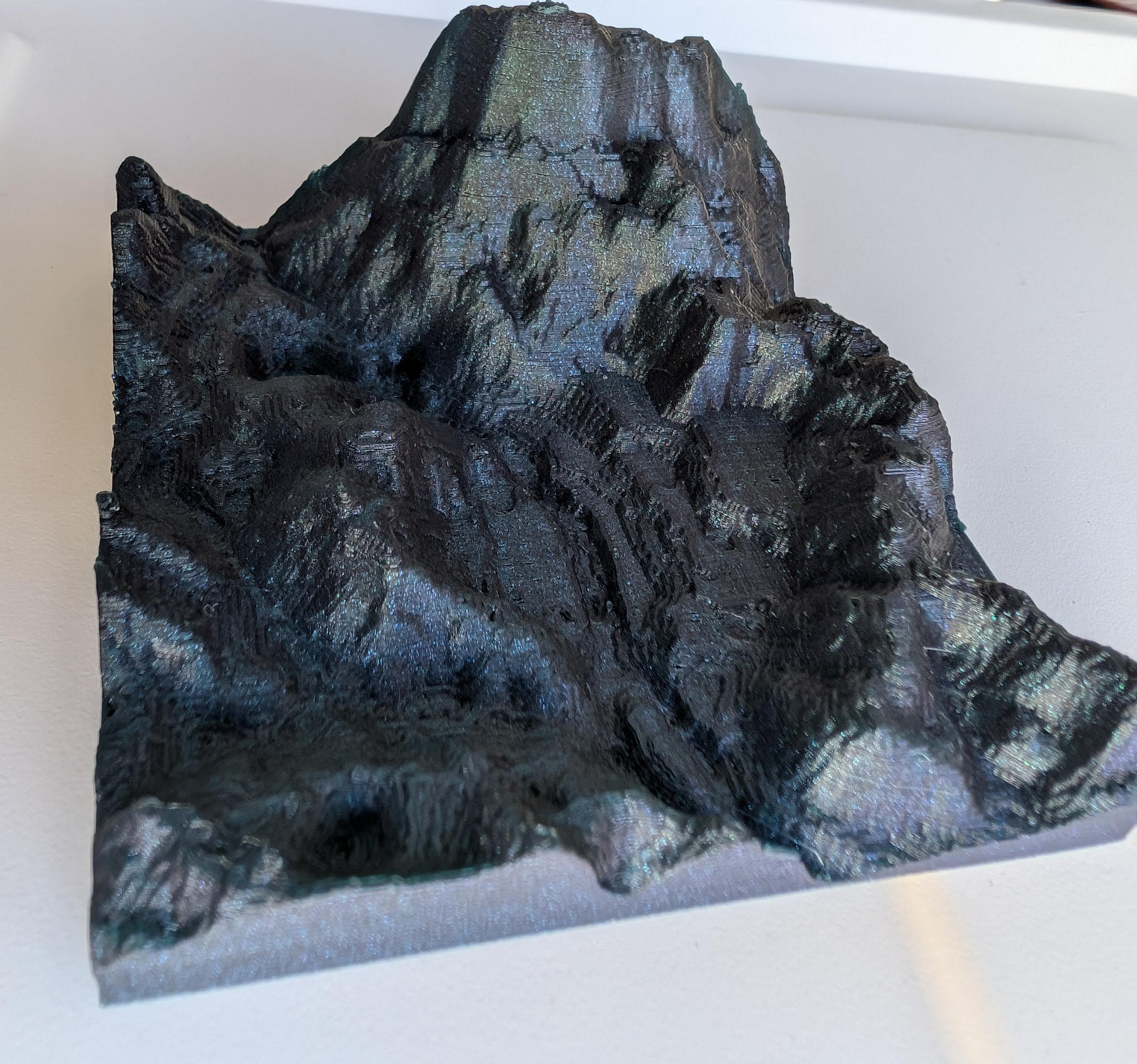 Small 3d printed square of Morrowind in a glitter blue PLA. It looks very majestic, with Balmora nestled in the middle. 