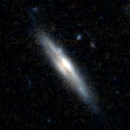 An edge-on spiral with an yellow, oval core and a disk extending to either side at about a 45 degree angle. The galaxy has a prominent dark dust lane cutting across it. An edge-on spiral with an yellow, oval core and a disk extending to either side at about a 45 degree angle. The galaxy has a prominent dark dust lane cutting across it.