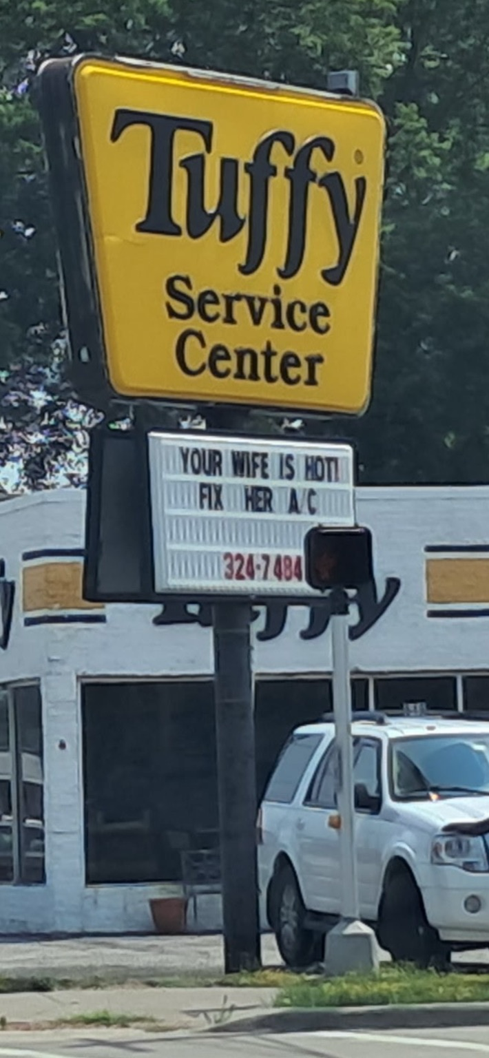 Mechanic shop sign that reads: YOUR WIFE IS HOT! Fix her a/c