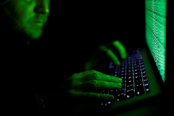 A man types on a computer keyboard in front of the displayed cyber code in this illustration picture taken on March 1, 2017. REUTERS/Kacper Pempel/Illustration/ File Photo Purchase Licensing Rights
