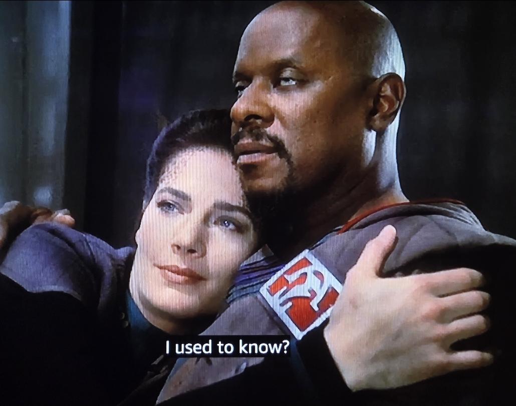 Jadzia Dax and Sisko hold each other.