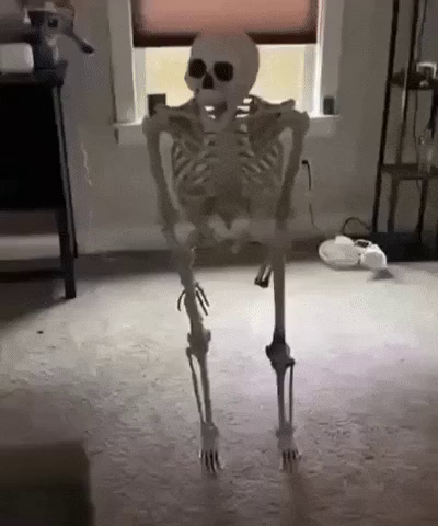 gif of a skeleton falling onto an interior room object and breaking into pieces