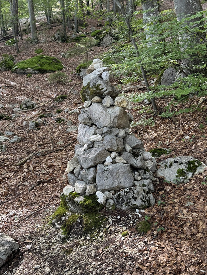 A small tower made of rocks. Hikers in Switzerland have an unwritten law. If you come across such a pile of rocks, put one on top of it to make it slowly grow.
