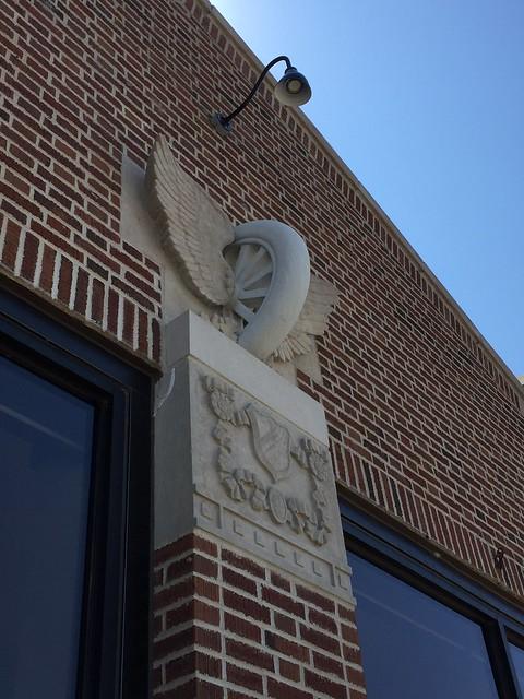 Close-up view of winged tire made of concrete or carved stone.