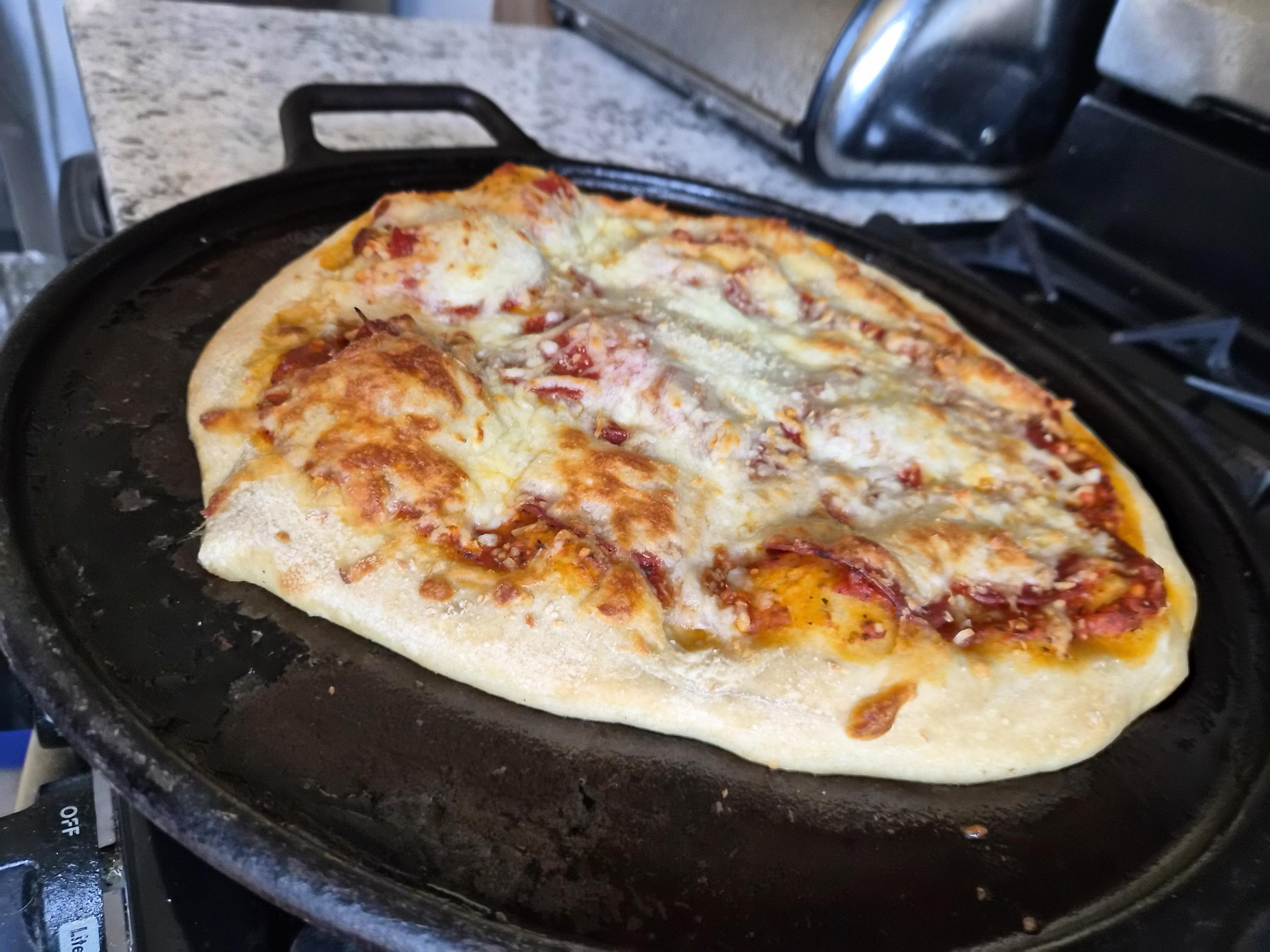 A cooked homemade pepperoni pizza